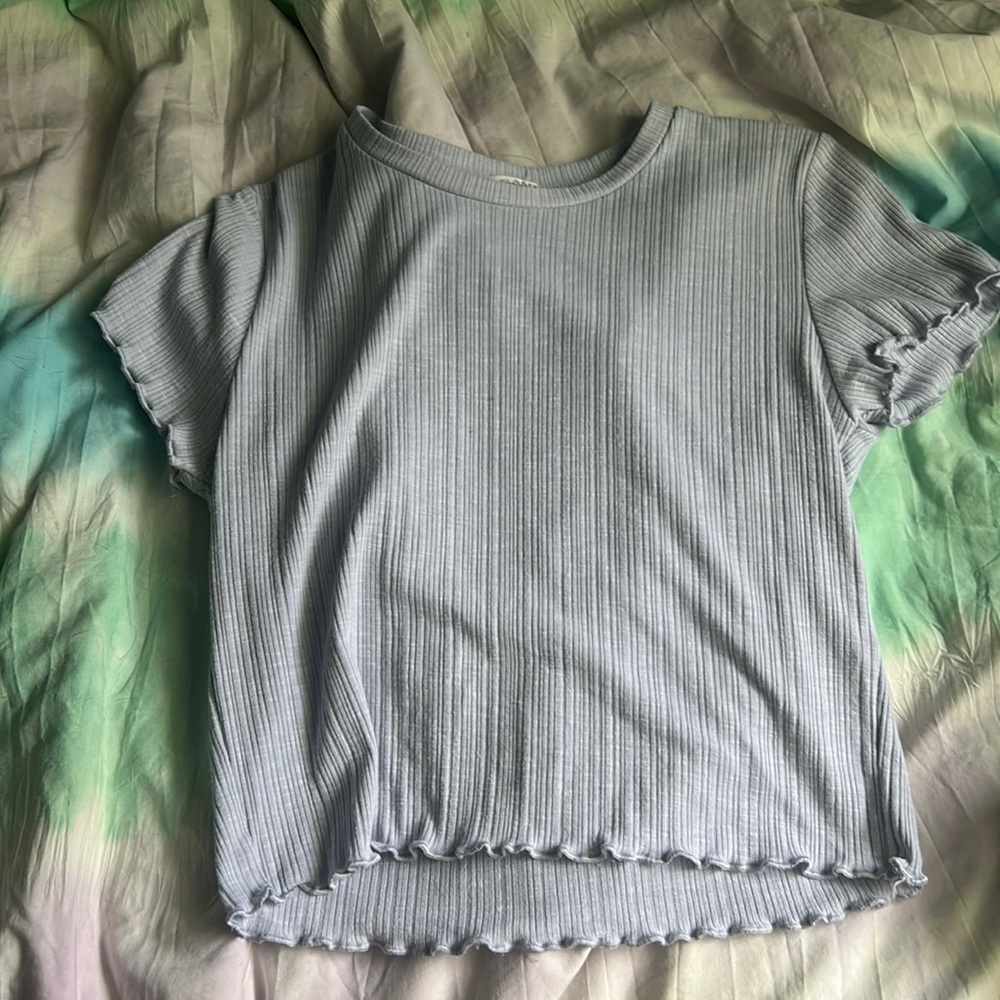 Purple garage t shirt with ruffles on the sleeves and the bottom.